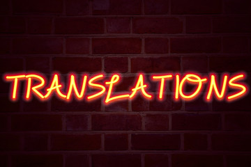 Translations neon sign on brick wall background. Fluorescent Neon tube Sign on brickwork Business...