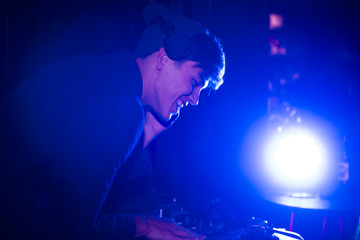 Fototapeta na wymiar DJ playing music in a night pub