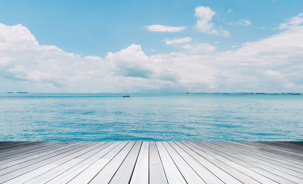 Wood, blue sea and sky background
