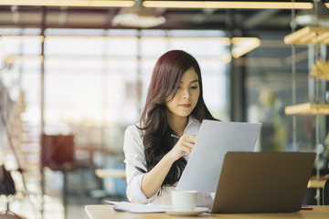 Cropped shot of an attractive young businesswoman working on a laptop in her office