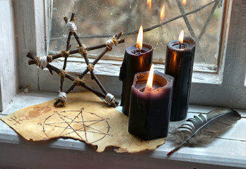 Black magic ritual with pentagram and black candles. Occult, esoteric, divination and wicca...