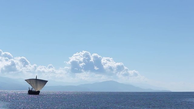Sailboat floats in the sea or ocean, an old style ship on the water