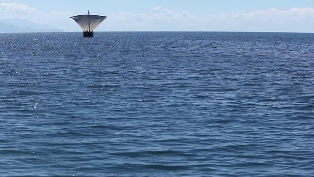 Sailboat floats in the sea or ocean, an old style ship on the water