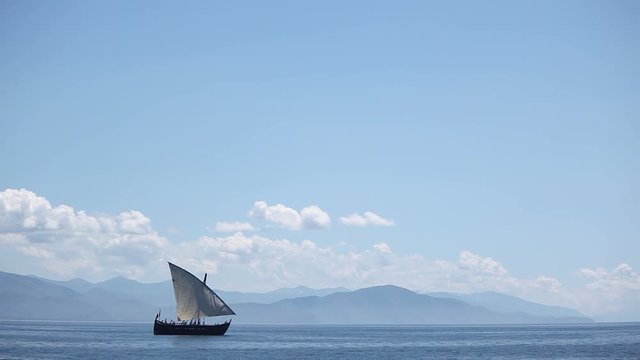 Sailboat floats in the sea or ocean, an old style ship on the water