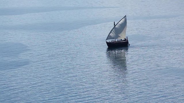 Sailboat floats in the sea or ocean, an old style ship on the water