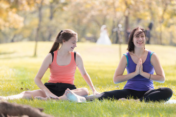 Holiday my Sisters
 doing yoga pose meditation in the public park Sport Healthy concept.