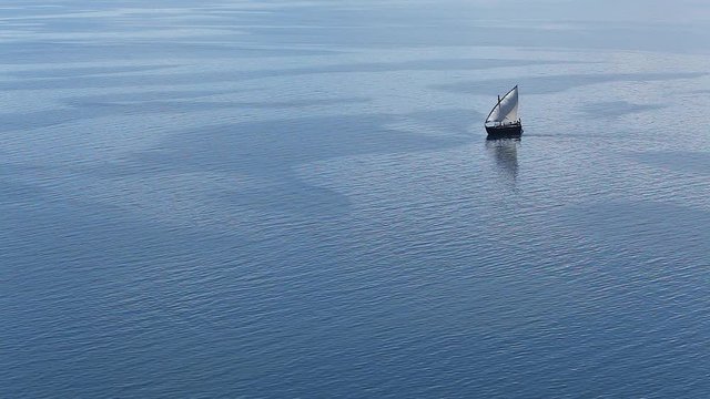 Sailboat floats in the sea or ocean, an old style ship on the water