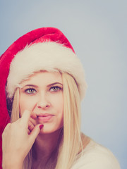 Woman in Santa hat thinking about Christmas