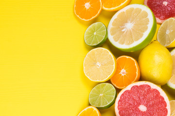 Fototapeta na wymiar yellow background for citrus with vitamin C and various fruits