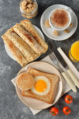 Egg, pancakes, cappuccino and orange juice