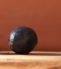 Isolated olive close up in front of a red backround