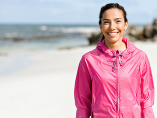Athletic woman in sportswear standing at the seaside