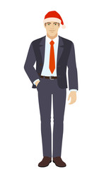 Businessman in Santa hat standing with hand in pocket