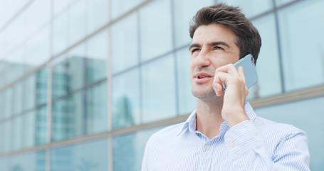 Hispanic businessman talk to mobile phone