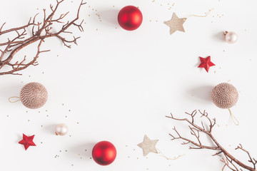Christmas composition. Christmas balls, beige and red decorations on white background. Flat lay, top view, copy space