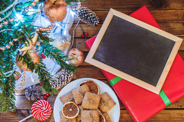 Christmas tree, toys and gifts with a clean slate for text top view