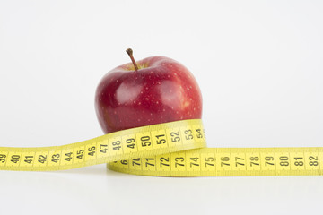 Red apple with measuring tape 
