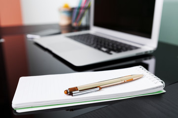 Top view of studying process with copybook, book and laptop. Cups of coffee on the table