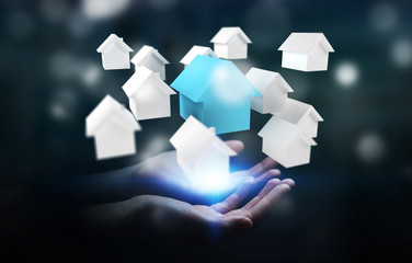 Businessman using 3D rendered small white and blue houses