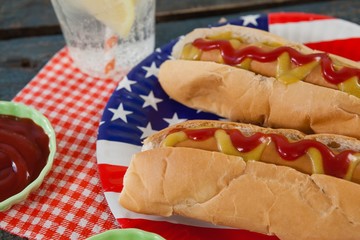 Close-up of hot dog served in plate on wooden table