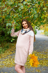 Pregnant woman walking in a park