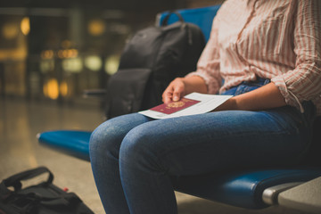 Woman with luggage awaiting her landing at the airport.