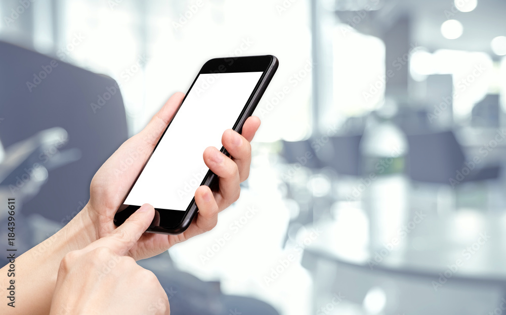 Poster Hand click mobile phone with blur bank corridor hall background bokeh light,White screen mock up template for adding your design or your text.