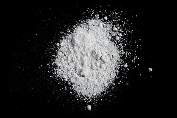 Obraz na płótnie Canvas White powder isolated on black background, dust or powder texture