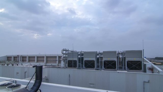 System of industrial central conditioning set on the roof of the building day to night timelapse