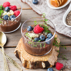 Healthy vegan chocolate chia pudding with berries and green thyme