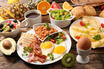 Fototapeta na wymiar breakfast with egg,bacon,bean,cheese and coffee cup