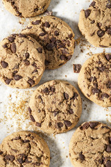 Cookies with dark chocolate chips on white plate.