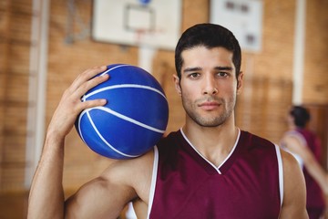 Confident basketball player holding a basketball