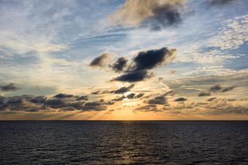 Naklejka premium Blue sea and sky with sun red light reflexted in the middle sea