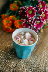 Fototapeta na wymiar Coffee with marshmallow in a light blue cup