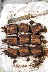 Chocolate brownies on baking paper. Gourmet conception.