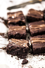 Chocolate brownies on baking paper. Gourmet conception.