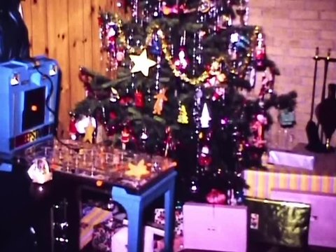 Slow pan of living room on Christmas morning full of toys left by Santa Claus in 1968