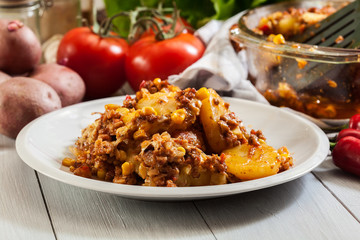 Portion of mexican potato casserole with minced meat