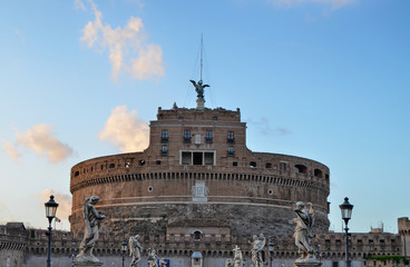 Castle of San Angelo Castel Sant Angelo and Ponte Sant Angelo bridge over the Tiber river, Rome, Italy. Statues on the sides and cloudy sky. Photo of 14 August 2014 at 8.00 pm