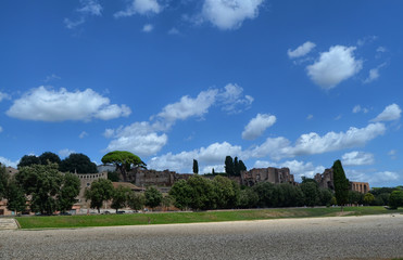 The ruins of the Circus Maximus and of the Domus Augustana in Rome, Italy. blue sky with white...