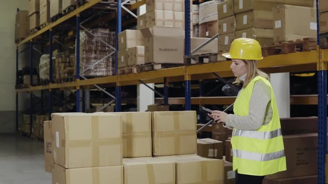 Woman warehouse worker with barcode scanner.