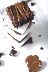Pieces of chocolate baked brownies in a stacked pile. Gourmet concept.