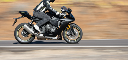 Fototapeta premium Biker riding motorbike of a high power motorcycle,on the road