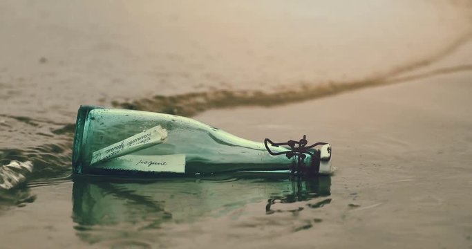 hand pick bottle with message out of water