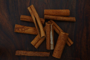 Cinnamons sticks on the brown table, close up