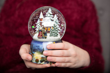 Christmas snowglobe in hands