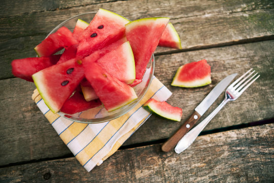 Watermelon cuts in bowl with cutlery