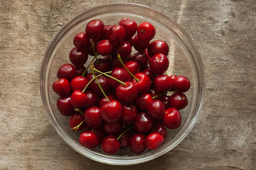 Cherries on a wooden background in natural light.