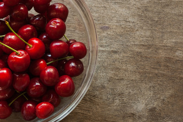Cherries on a wooden background in natural light.